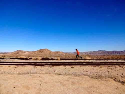 Sam running down the railroad tracks.